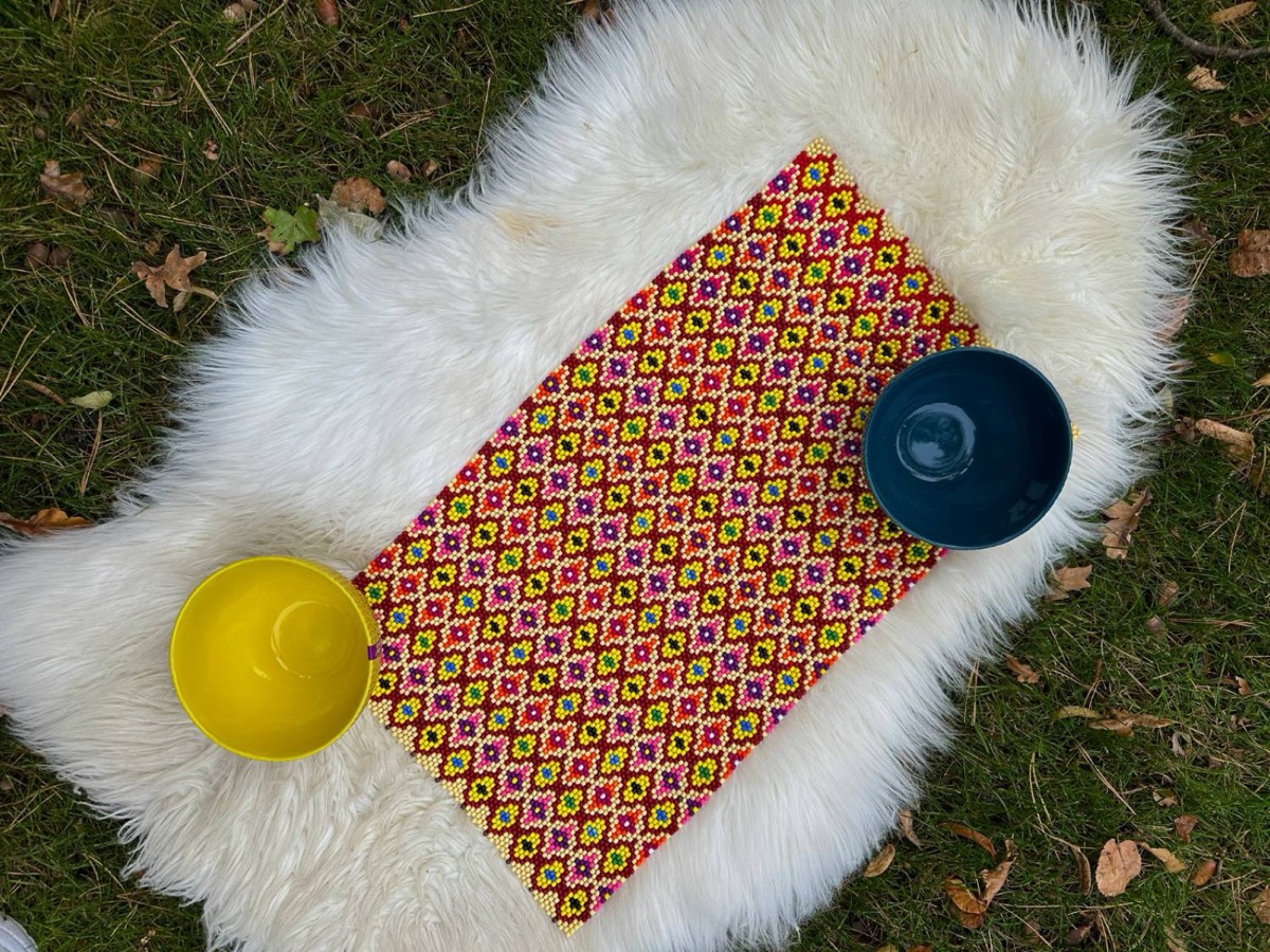 The flower grid piece on a sheepskin with two bowls