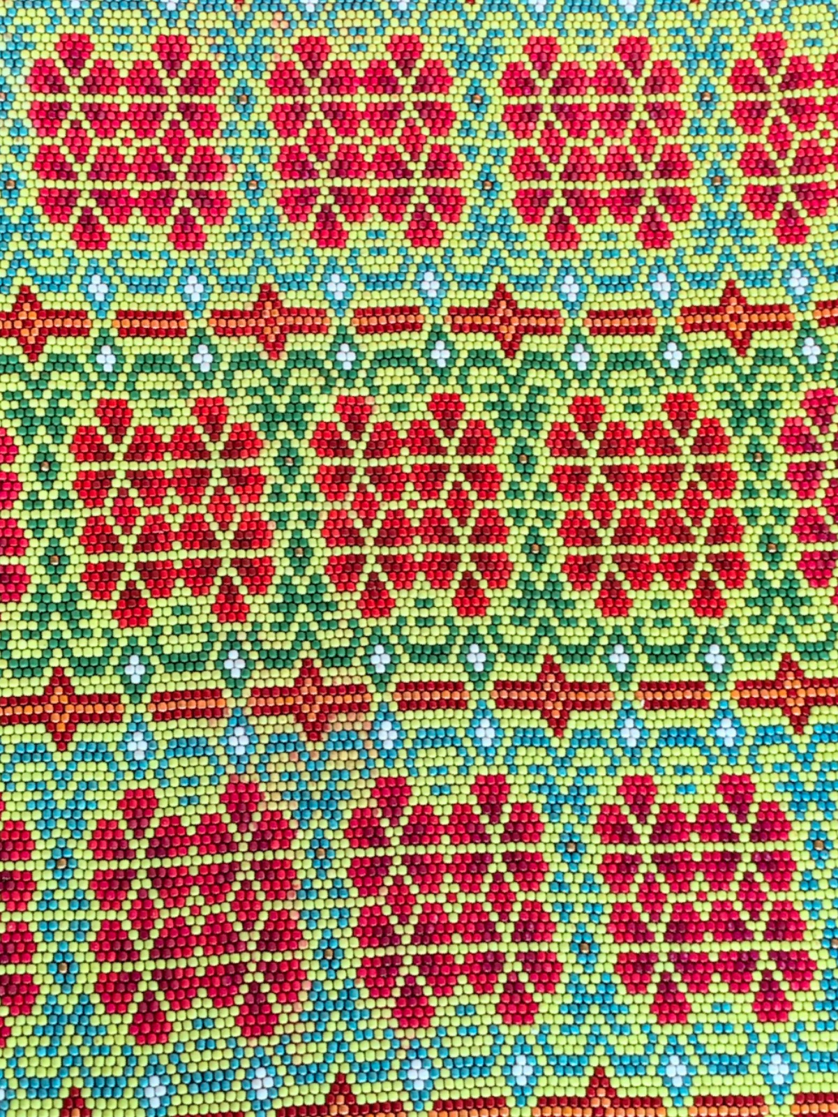 Close-up of the green square: red bead flowers framed in green and turquoise