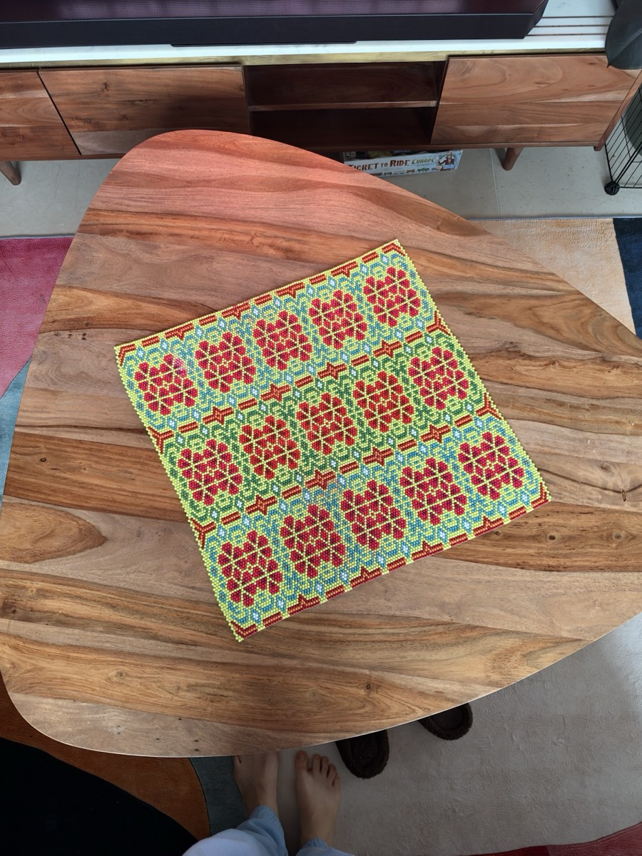 Green square on a wooden dining table, seen from above