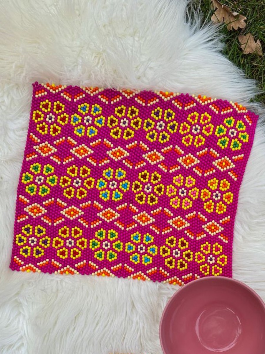Magenta flowers on a sheepskin: yellow bead flowers on magenta
