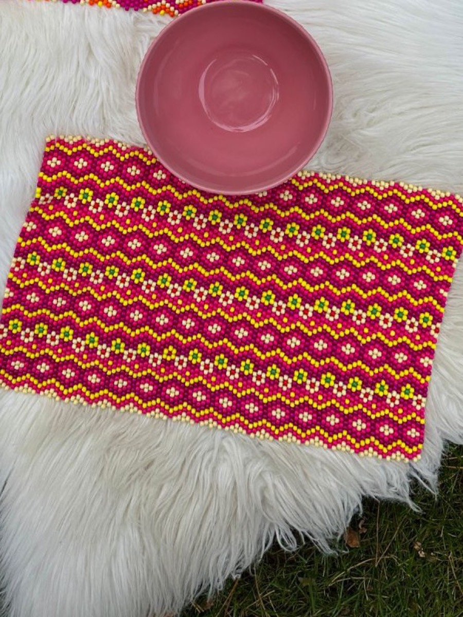 Pink waves on a sheepskin next to a pink bowl