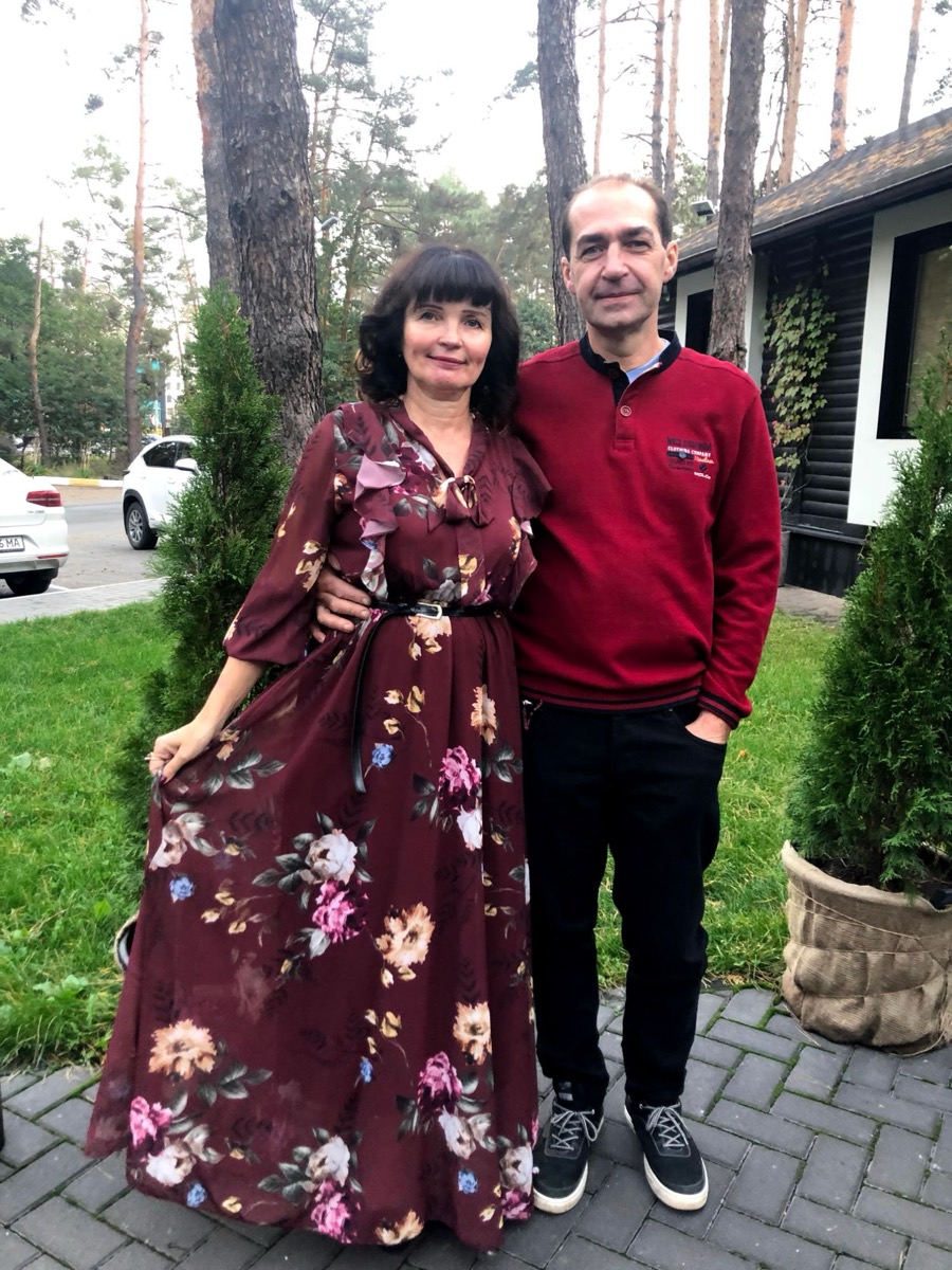 Volodymyr and Elza's mum standing together outside under pine trees