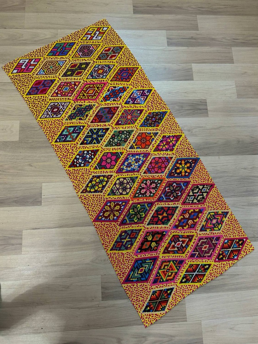 Yellow diamond runner laid out on a wooden floor